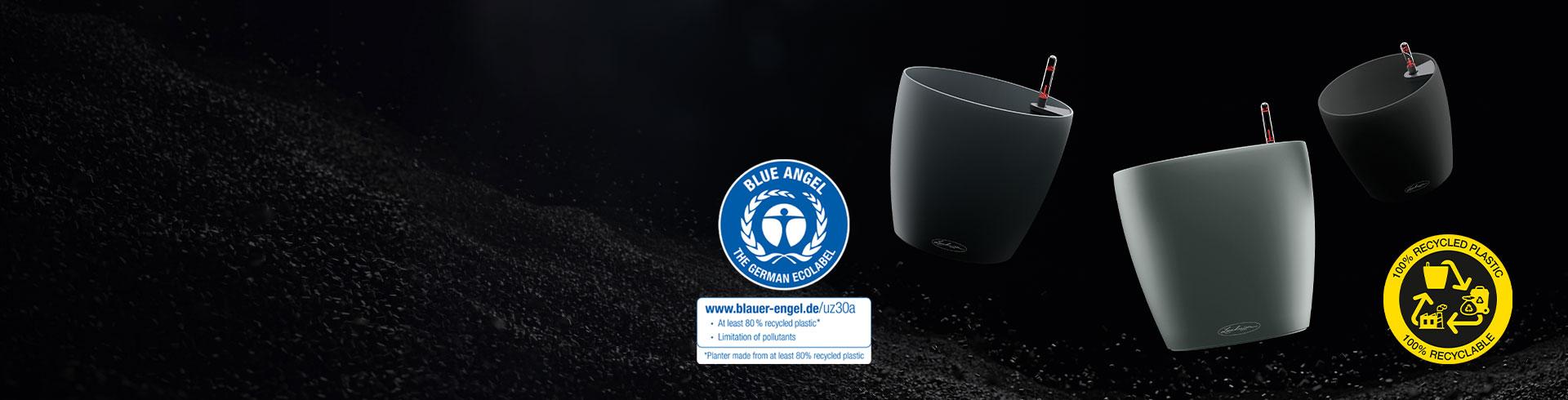 Three LECHUZA planters on a black background with sustainability seal.